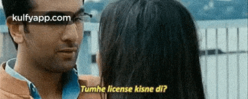 a man and woman are looking at each other and the man is asking the woman if she has a license
