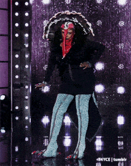 a woman in a turkey costume stands on stage