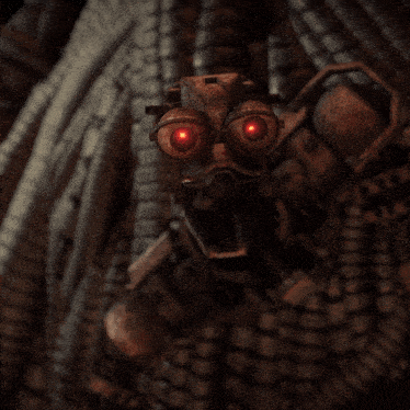 a close up of a robot 's face with red eyes