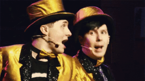two men wearing top hats and bow ties are looking at each other
