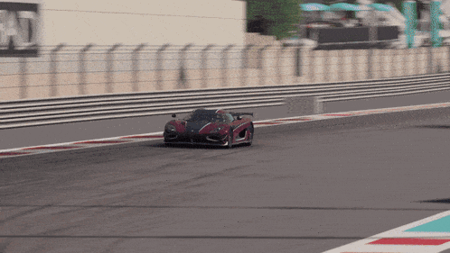 a red sports car is driving on a track with a sign that says hadetha