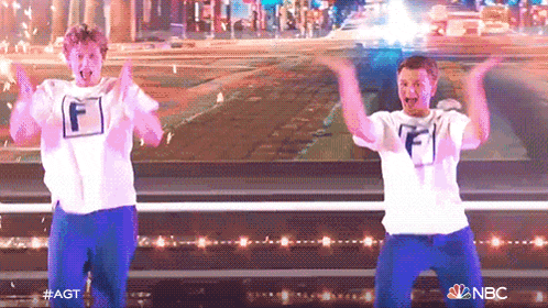 two men wearing white shirts with the letter f on them are dancing on stage