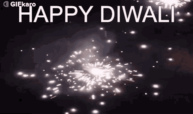 a gif that says happy diwali with fireworks in the background .