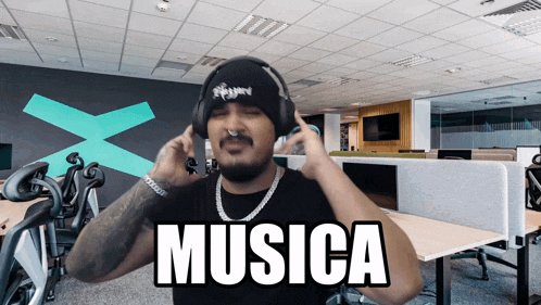 a man wearing headphones and a beanie is listening to musica
