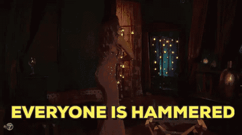 a woman in a dress is dancing in a room with the words everyone is hammered behind her