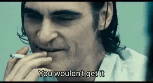 a close up of a man smoking a cigarette and saying `` you wouldn 't get it '' .