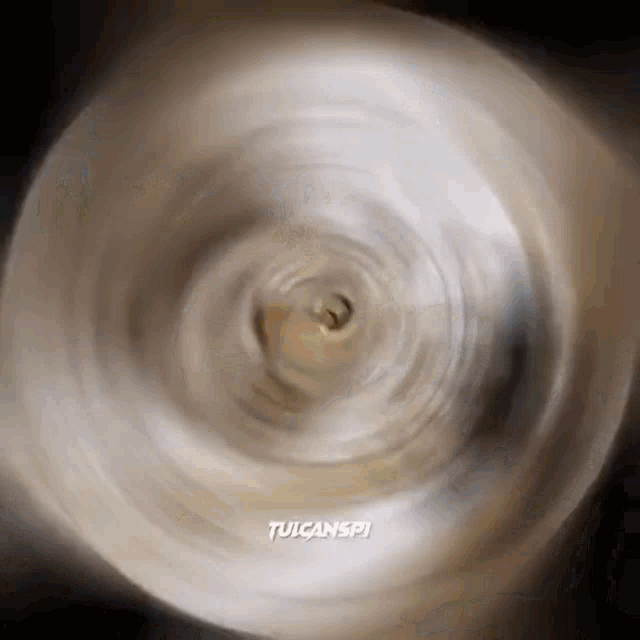a close up of a spinning object with the words tulcanspi written on the bottom