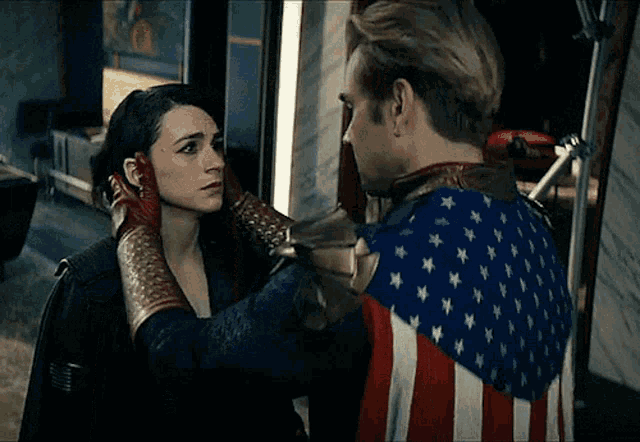 a man in an american flag costume holds a woman 's face