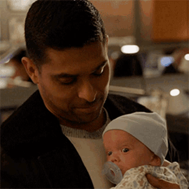 Carlos Madrigal Wilmer Valderrama GIF - Carlos Madrigal Wilmer Valderrama Holding A Baby GIFs