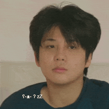 a close up of a young man 's face with the words s-e-z-z written below it