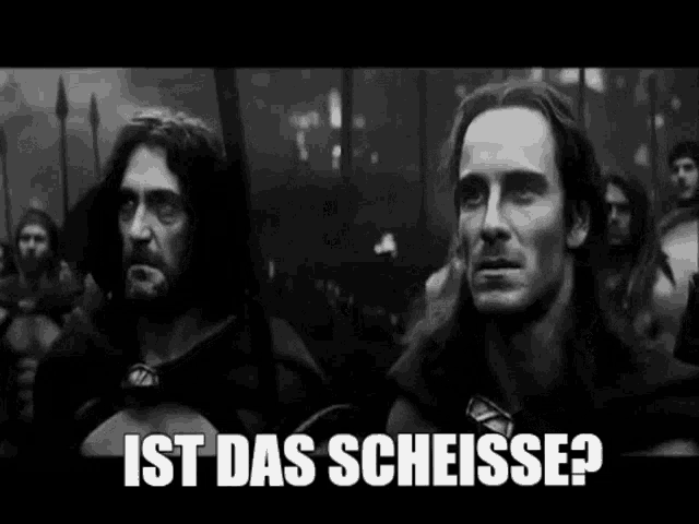 a black and white photo of two men standing next to each other with the words `` ist das schisse ? ''