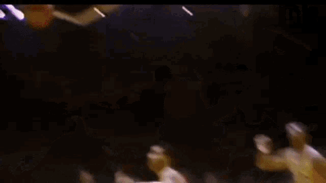 a blurry picture of a basketball game with a player wearing a number 21 jersey