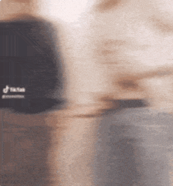 a blurry picture of a person wearing a tik tok hat .