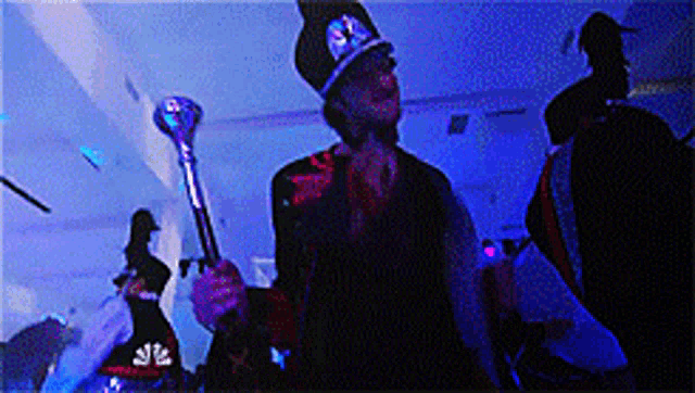 a man in a top hat is holding a cane and a trophy