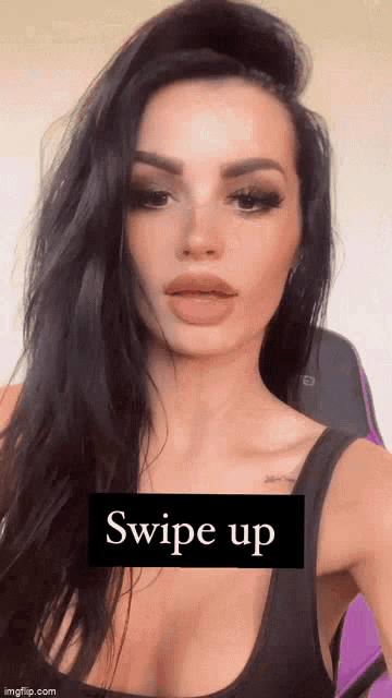 a woman with long black hair is taking a selfie with a swipe up sign in the corner