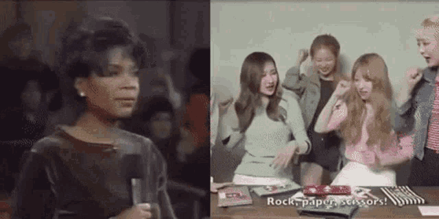 a woman is talking into a microphone next to a group of girls sitting at a desk .
