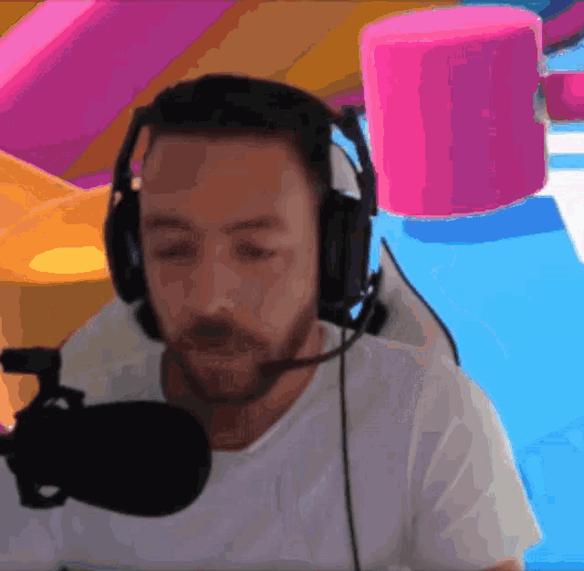 a man wearing headphones and a microphone looks at something