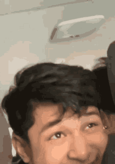 a close up of a man 's face on a plane .