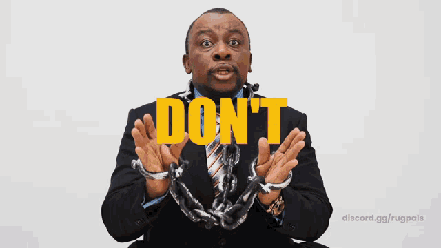 a man in a suit and tie with chains around his wrists and the word mmmint written above him