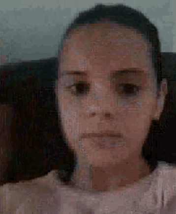 a pixelated image of a woman 's face with a serious look on her face .