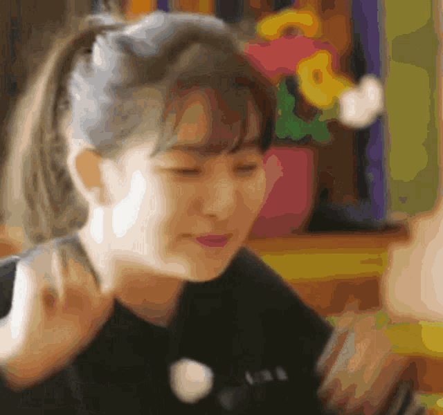 a blurry picture of a woman with a ponytail looking down
