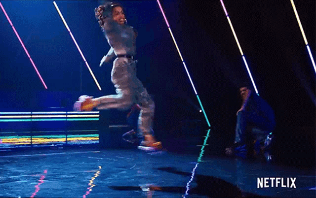 a person is jumping in the air with a netflix logo in the background