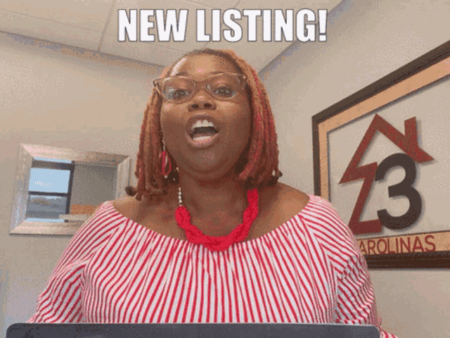 a woman in a red and white striped shirt is standing in front of a sign that says new listing