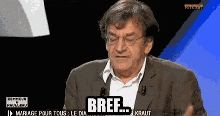 a man in a suit and glasses says bref on a tv screen