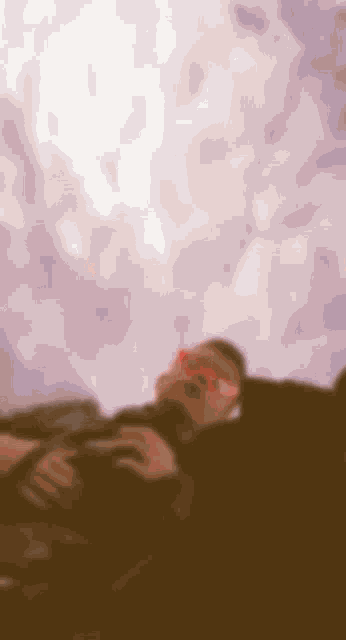 a blurry picture of a man wearing red sunglasses taking a picture