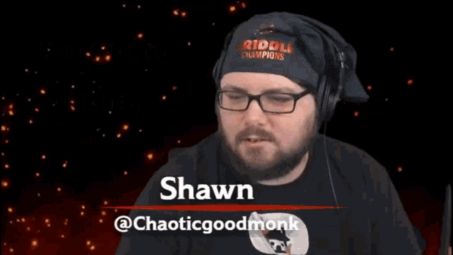 a man wearing glasses and a bandana that says riddle champions