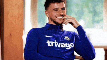 a man wearing a blue shirt that says triviago on it