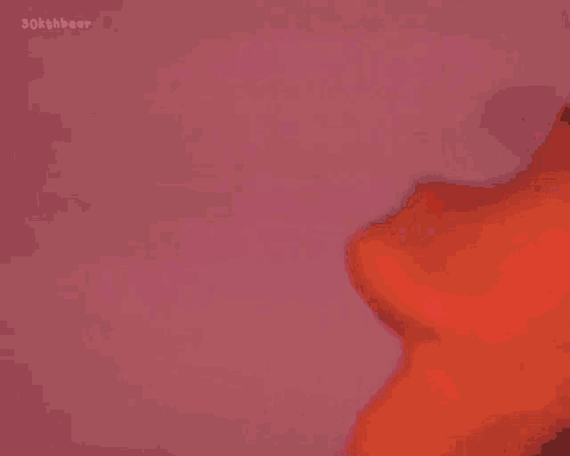 a close up of a person 's neck with a red light behind it .