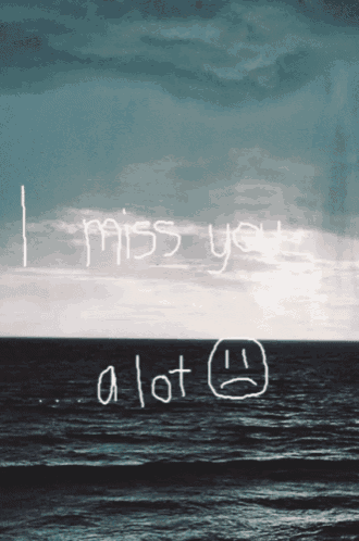 a picture of the ocean with the words " i miss you a lot " written in the sky
