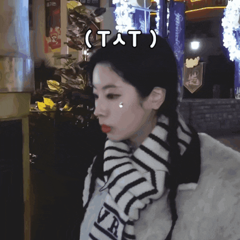 a woman with a scarf around her neck has the word tat written above her head