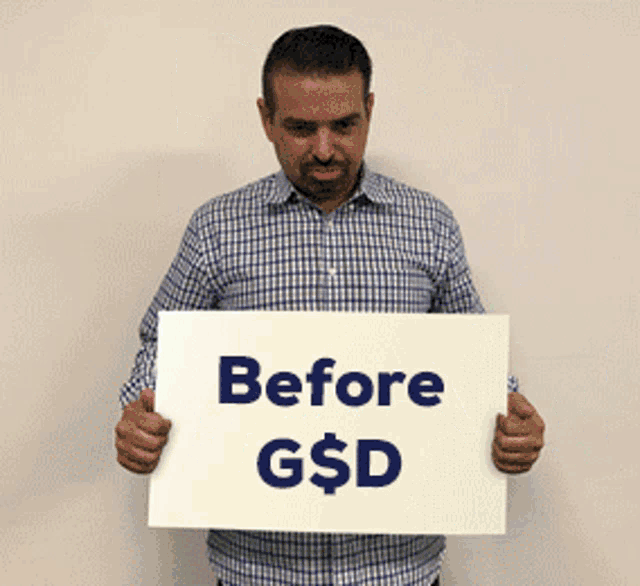 a man in a plaid shirt is holding a sign that says before g $ d