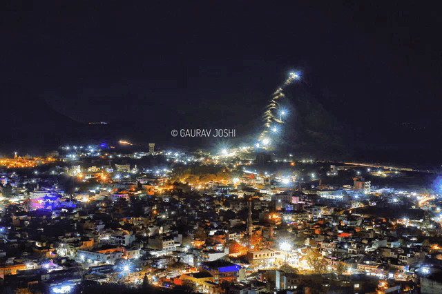an aerial view of a city at night with gaurav joshi written on the bottom left