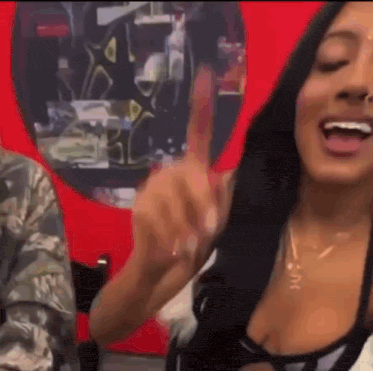 a woman with long black hair is giving a thumbs up sign