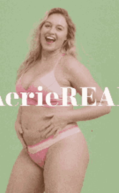 a woman in a pink bra and thong is standing in front of a green background with the word lingerie written on it