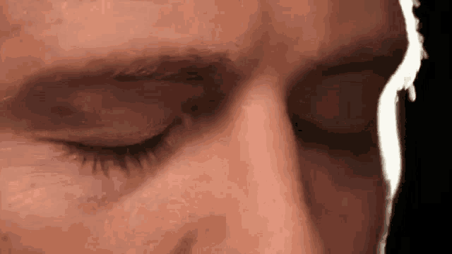 a close up of a man 's eyes with a white line coming out of them .