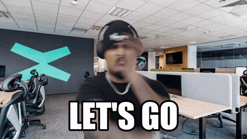 a man wearing headphones says let 's go in front of an office