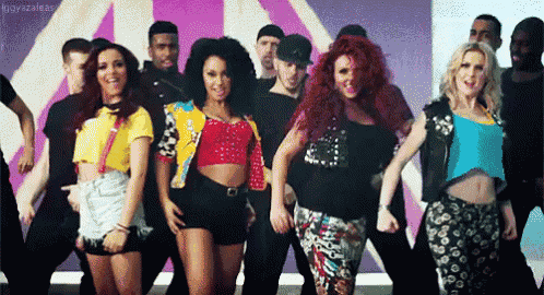 a group of people are standing next to each other and dancing in front of a purple background .