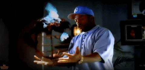 a man in a blue hat is standing in front of a tv screen that says hi masters hip-hop