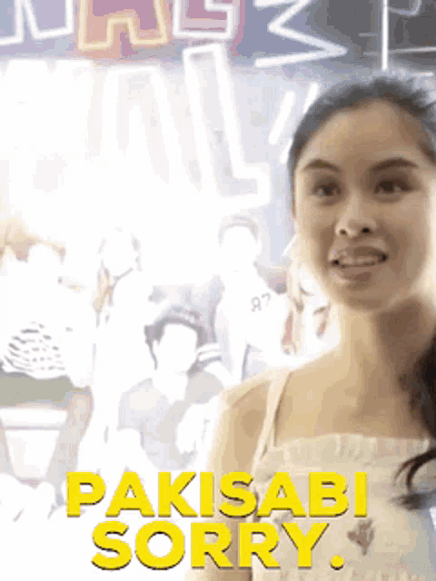 a woman is standing in front of a neon sign that says pakisabi sorry