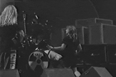 a black and white photo of a man playing drums