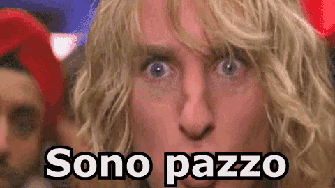 a close up of a man 's face with the words sono pazzo written on it