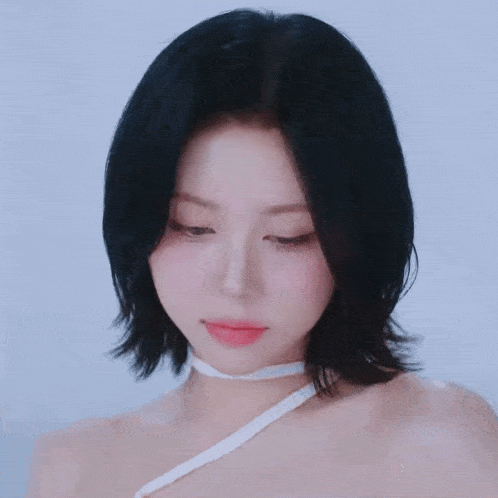 a close up of a woman 's face with a white ribbon around her neck
