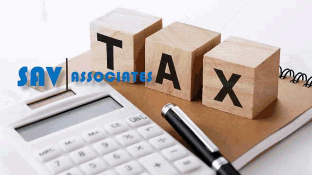 the word tax is written on wooden blocks next to a pen and a calculator