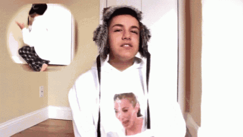 a person wearing a white hoodie with a picture of a woman on the front