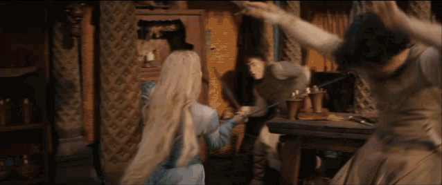 a woman in a blue dress is holding a sword in front of a man