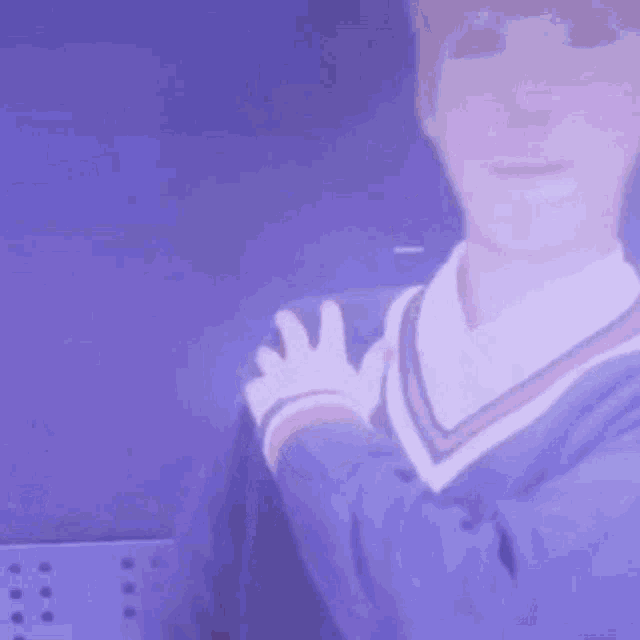 a close up of a person wearing a purple jacket and sweater .